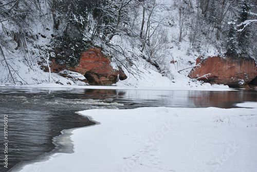 River in the winter near rocky mountains