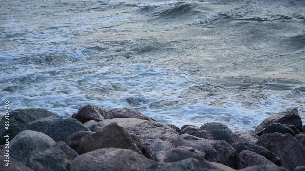 sea waves hitting a rock. the stormy sea impact the granite stones.