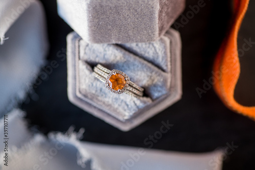 overhead view of orange stone wedding ring in box © Holly