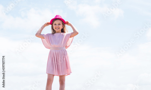 happy child in summer dress on sky background, fashion
