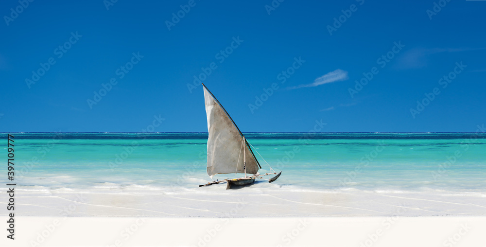 An Exotic Sail Boat Sits On White Sand In The Tropics