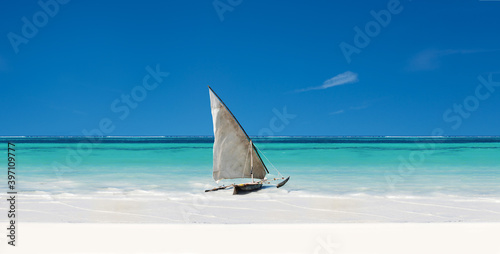 An Exotic Sail Boat Sits On White Sand In The Tropics