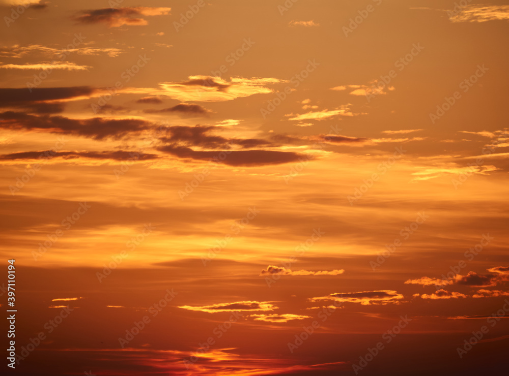 Fototapeta premium background - bright orange sunset sky with clouds