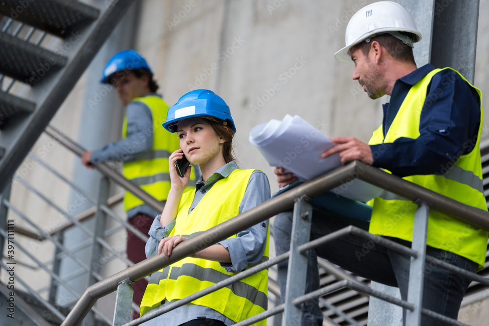 lady engineer talking on the phone in the factory lady engineer talking on the phone in the factory