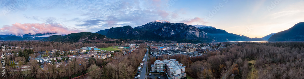 Aerial Panoramic View of Residential Homes in a touristic city. Colorful Sunset Sky. Taken in Squamish, North of Vancouver, British Columbia, Canada.
