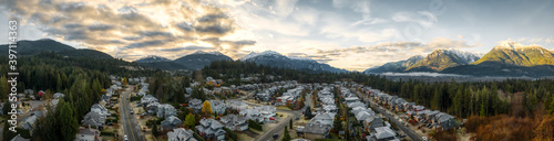 Aerial Panoramic View of Residential Homes in a touristic city. Colorful Sunrise Sky. Taken in Squamish, North of Vancouver, British Columbia, Canada.