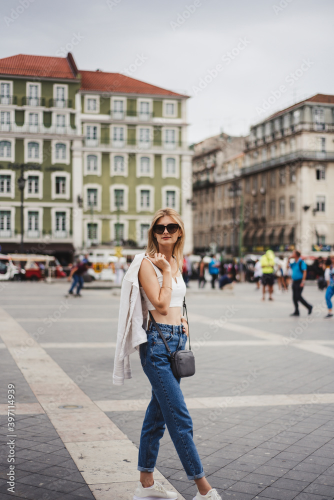 beautiful girl walking the streets in portugal. the concept of reflection and mystery