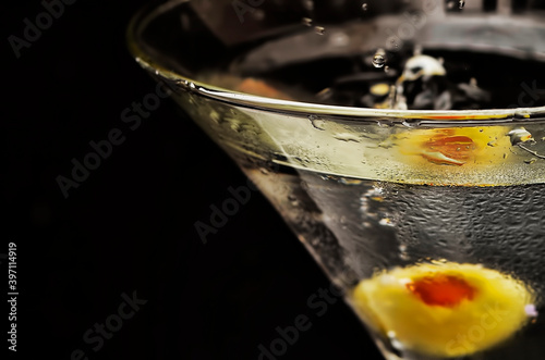 macro cocktail in a glass with splash and olive