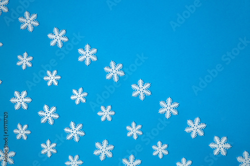 Diagonal Christmas snowflake composition.Snowflakes on a blue background.Creative minimal Christmas art. Flat lay, copy space, above, empty space for text,border.