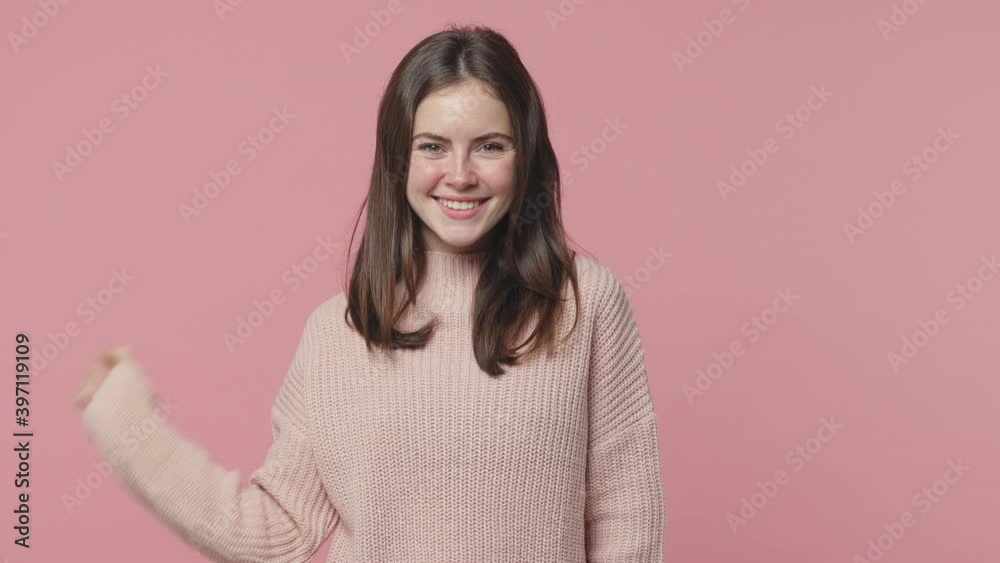 Secret smiling brunette young woman 20s years old in pastel sweater posing isolated on pink background studio. People lifestyle concept. Saying hush be quiet with finger on lips shhh gesture blinking Secret smiling brunette young woman 20s years old in pastel sweater posing isolated on pink background studio. People lifestyle concept. Saying hush be quiet with finger on lips shhh gesture blinking