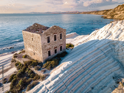 Fototapeta Naklejka Na Ścianę i Meble -  Punta Bianca, Agrigento in Sicily Italy White beach with old ruins of an abandoned stone house on white cliffs. Sicilia Italy, couple on vacation in Italy