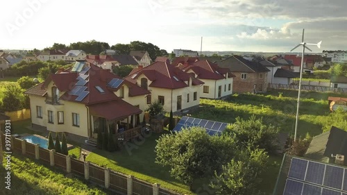 Wallpaper Mural Aerial view of an autonomous house with solar panels on roof and wind generator turbine for producing clean cheap electricity. Torontodigital.ca