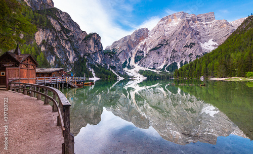 path around iconic mountain lake Pragser Wildsee (Lago di Braies) in Dolomites, Unesco World Heritage, South Tyrol, Italy; Mount Seekofel and boatshouse mirroring in the clam clear water photo