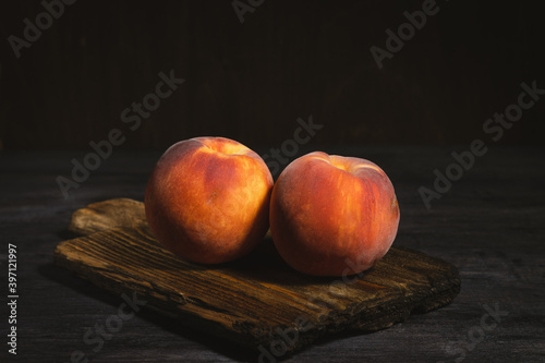 Peaches on cutting board, frash and juicy fruit photo