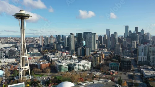 Birdseye trucking shot of the Space Needle Belltown, near Elliott Bay, Seattle with few people downtown, in the commercial district of Seattle, Washington during the pandemic photo