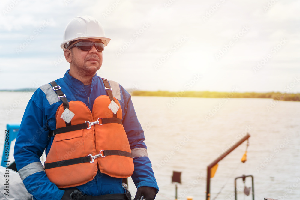 Deck Officer on deck of offshore vessel or ship , wearing PPE personal protective equipment. Deck Officer on deck of offshore vessel or ship , wearing PPE personal protective equipment.