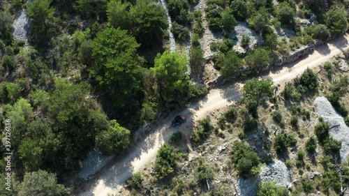 Tracking Aerial Shot of Two Beach Buggies Travelling Along Sandy Lane photo