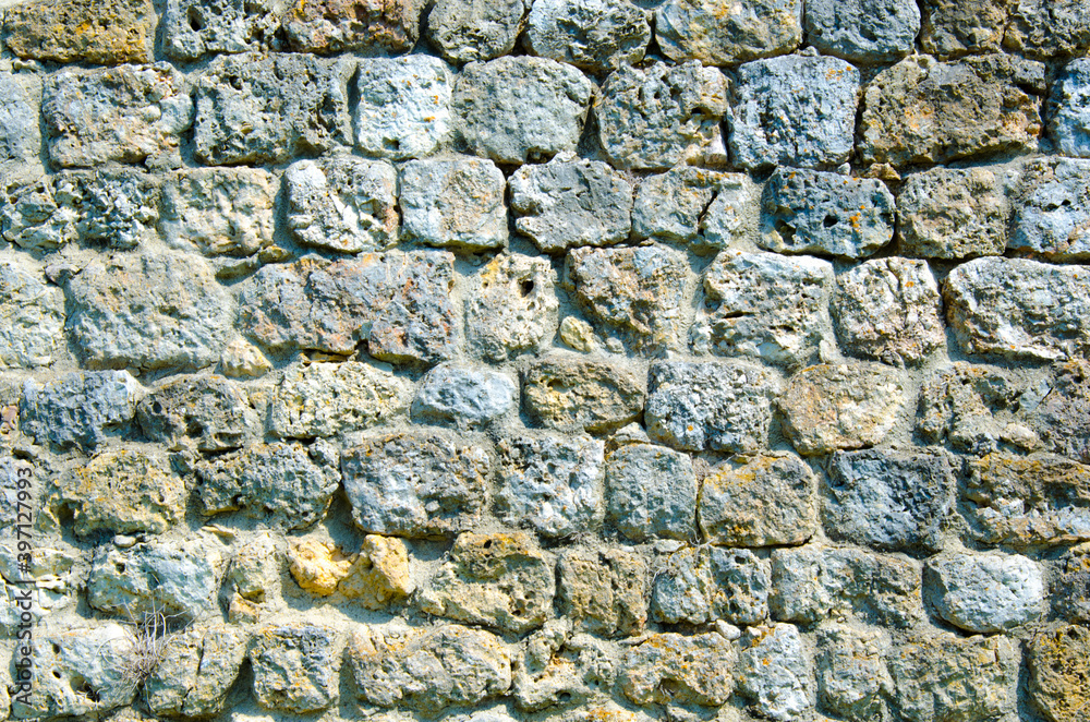 Fragment of a fortified wall made of stones and cemented with cement mortar Fragment of a fortified wall made of stones and cemented with cement mortar