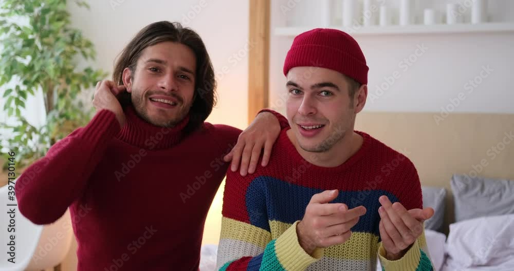 Happy gay couple making a vlog video at home