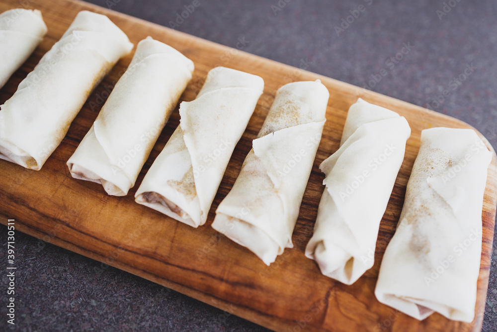 plant-based food, vegan homemade spring rolls with stir fried vegetables filling before geting cooked plant-based food, vegan homemade spring rolls with stir fried vegetables filling before geting cooked