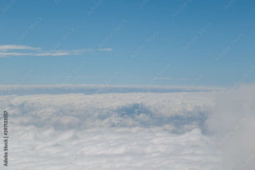 Fototapeta premium High angle shot of forest on hills covered with clouds