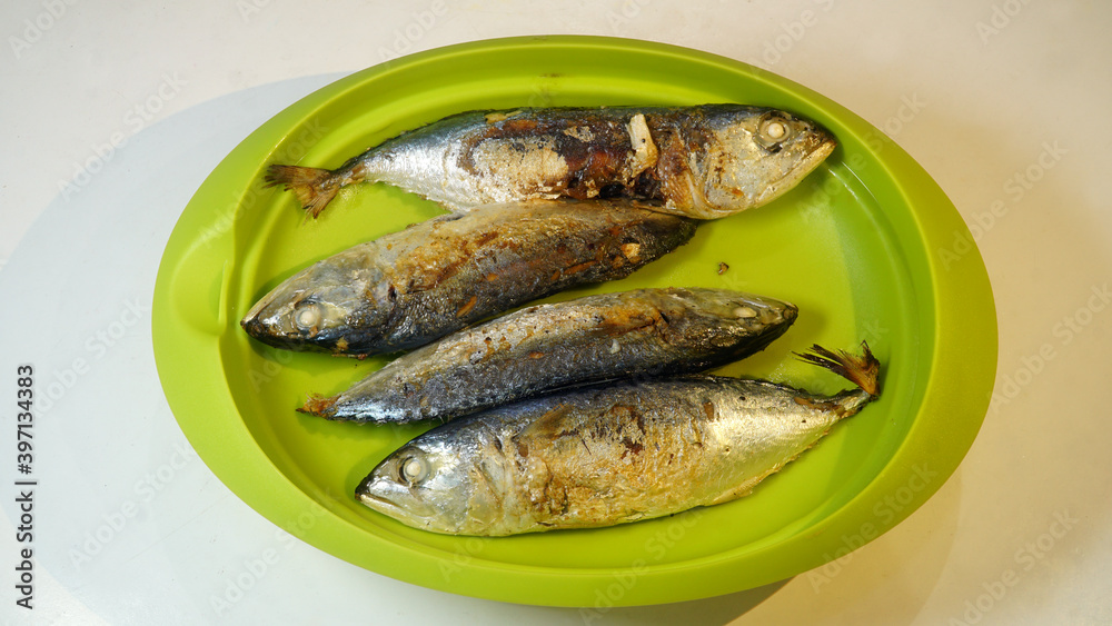 Pindang fish after frying is served on a green plate Pindang fish after frying is served on a green plate