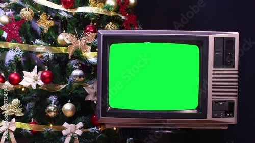 Christmas tree behind vintage old tv with green screen