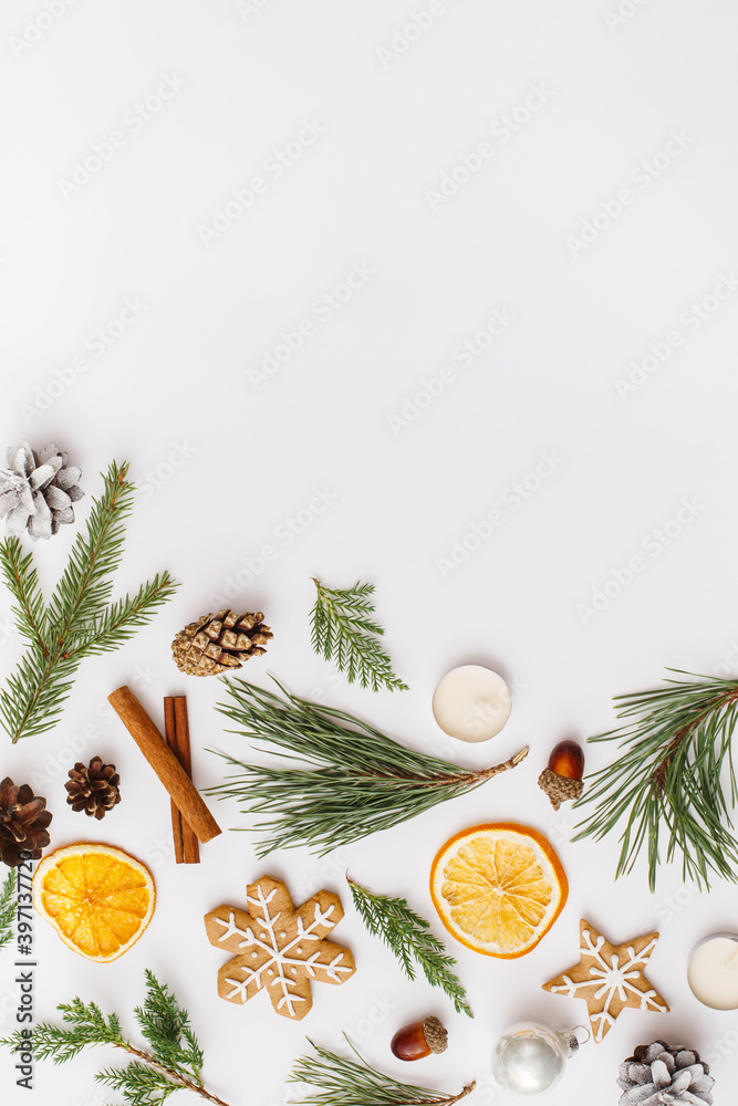 Christmas, winter, new year composition. Fir tree branches, pine cone, dried oranges, cinnamon sticks, gingerbread, candles on white background. Flat lay, top view, copy space Christmas, winter, new year composition. Fir tree branches, pine cone, dried oranges, cinnamon sticks, gingerbread, candles on white background. Flat lay, top view, copy space