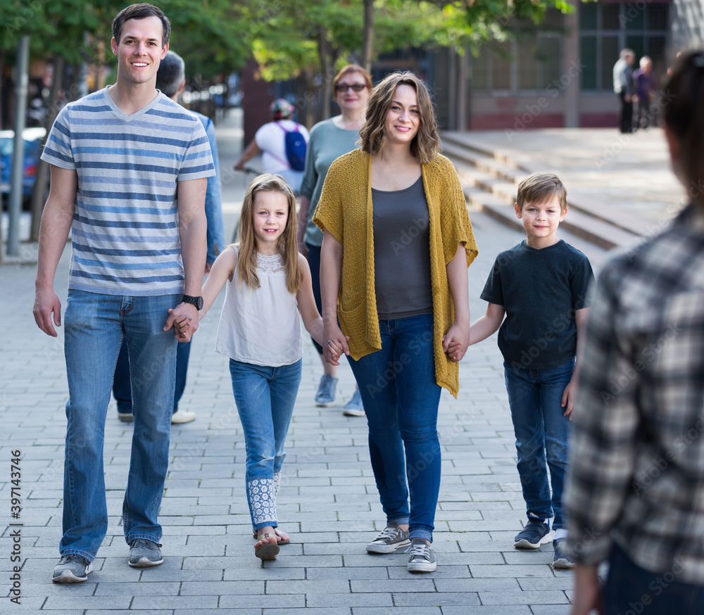 Friendly and positive family going in the park on weekend together..