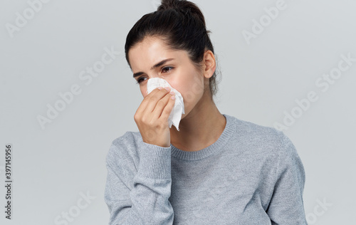 Woman holding napkin near face health problems runny nose flu