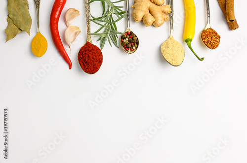 Fototapeta Naklejka Na Ścianę i Meble -  Various spices in spoons, copy space, white background
