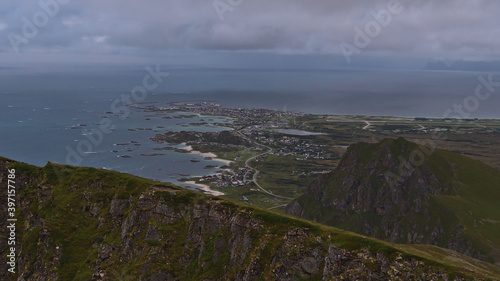 Slika na platnu Panoramic view of fishing village Andenes located on the shore of Norwegian Sea in the north of Andøya island, Vesterålen, Norway with airfield and rugged mountains on cloudy summer day
