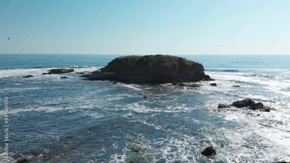 Rock Formations Between Crashing Sea Waves Against Blue Sky In Bulgarian Black Sea Coast In Lozenets, Burgas, Bulgaria. - Aerial Pullback Shot Rock Formations Between Crashing Sea Waves Against Blue Sky In Bulgarian Black Sea Coast In Lozenets, Burgas, Bulgaria. - Aerial Pullback Shot