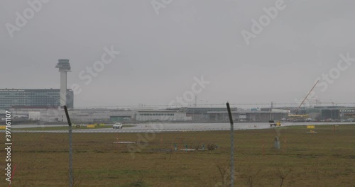 Luggage and security cars in the runway of Arlanda airport on rainy day photo