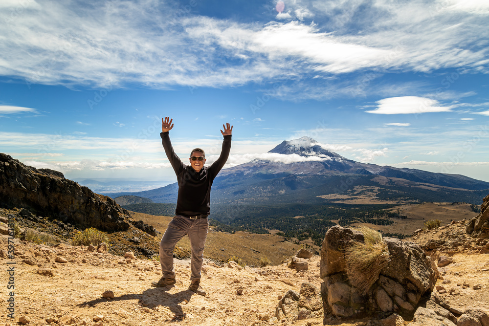 Man reached the top of the mountain.hiker observes the orizonte in the chasm of the Iztaccihuatl volcano Popocatepetl National Park, Mexico. concept Sport and active life Man reached the top of the mountain.hiker observes the orizonte in the chasm of the Iztaccihuatl volcano Popocatepetl National Park, Mexico. concept Sport and active life