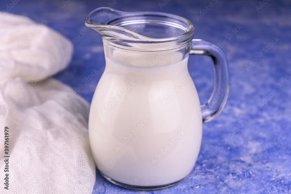 Decanter with milk on a light blue background.
Close-up. Decanter with milk on a light blue background.
Close-up.