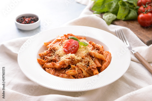 Plate of penne pasta with tomato sauce on table