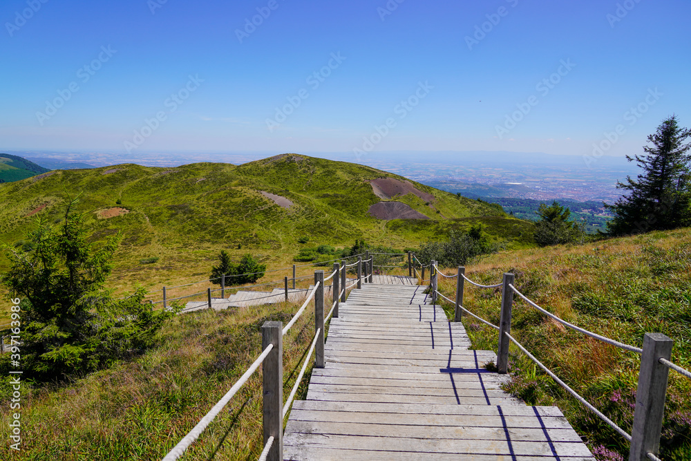 wooden staircase pedestrian trail access to mountain pariou in Puy de Dôme volcano in Auvergne france