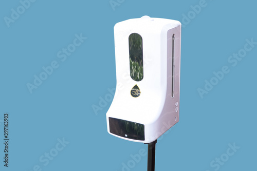 Automatic Alcohol Dispenser at cafe' shop for protect covid19 on blue background with clipping path.