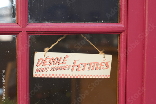 Fototapeta Naklejka Na Ścianę i Meble -  windows sign shop panel write in french desole nous sommes ferme means sorry we are closed on store entrance