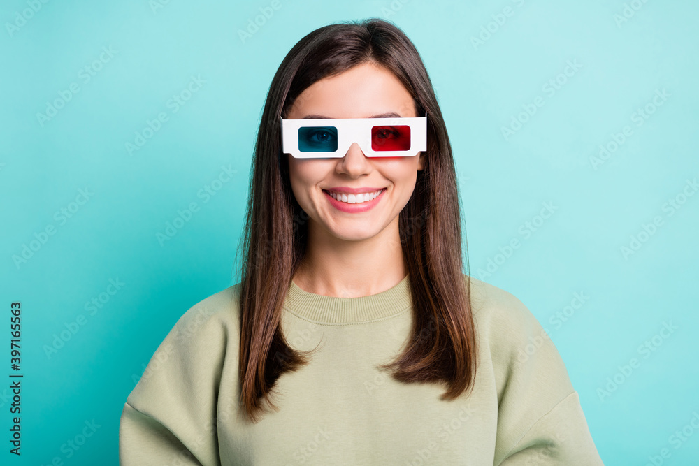 Photo portrait of smiling woman in 3d glasses isolated on vivid cyan colored background Photo portrait of smiling woman in 3d glasses isolated on vivid cyan colored background