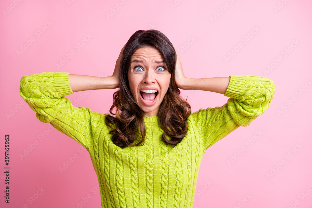 Photo of sad depressed wavy lady wear green sweater arms cover ears shouting isolated pastel pink color background Photo of sad depressed wavy lady wear green sweater arms cover ears shouting isolated pastel pink color background