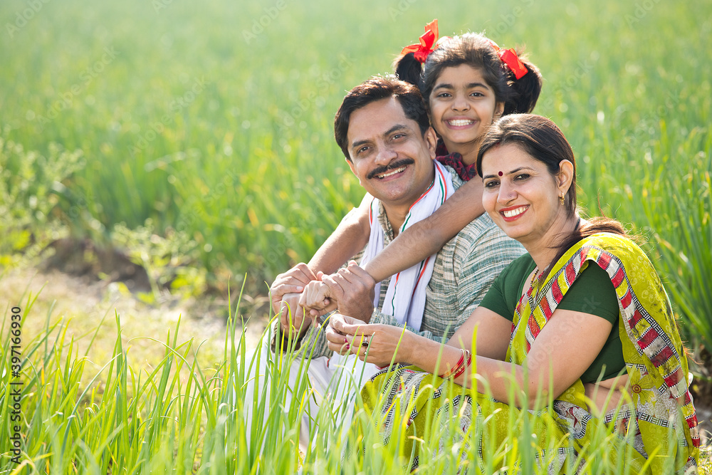 Fototapeta premium Happy Indian family in agricultural field