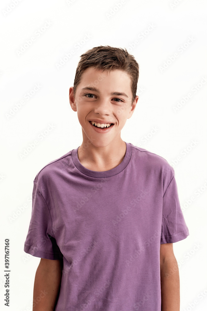 Close up portrait of happy teenaged disabled boy with cerebral palsy smiling at camera, posing isolated over white background Close up portrait of happy teenaged disabled boy with cerebral palsy smiling at camera, posing isolated over white background