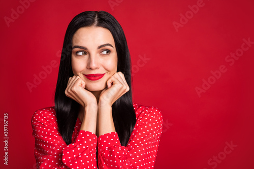 Close-up portrait of lovely cheery minded lady looking aside copy space advert decide isolated over bright red color background © deagreez