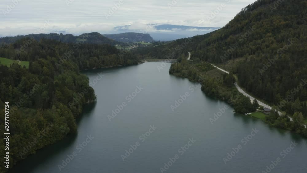 Freibach reservoir at the south Austrian Alps on cloudy grey day, Aerial flyover rising shot Freibach reservoir at the south Austrian Alps on cloudy grey day, Aerial flyover rising shot