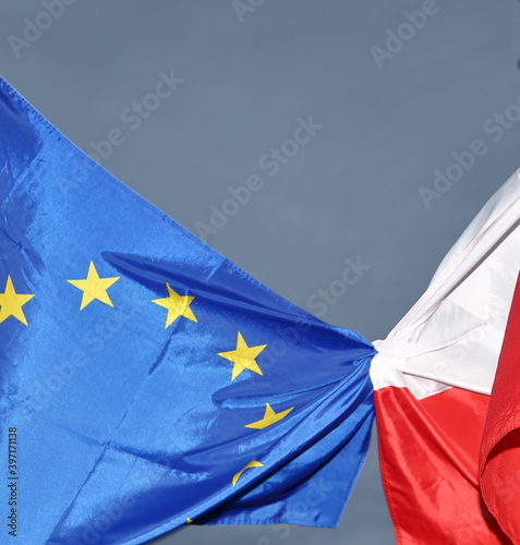 flag of European Union and Poland tied together to symbolize friendship, cooperation and membership
