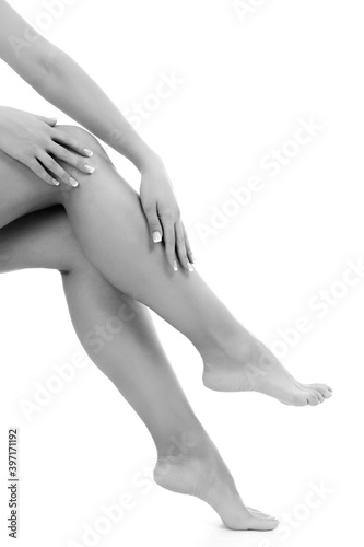 Female hands and legs on white background, copyspace
