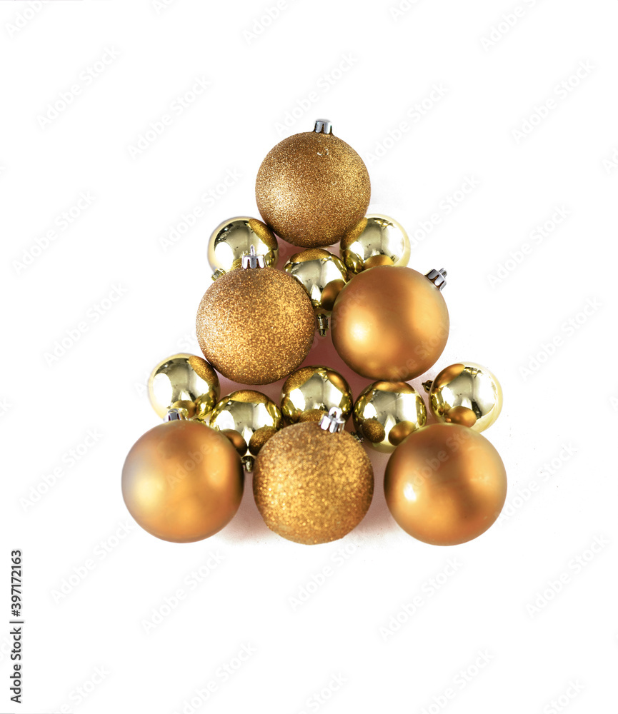 Christmas tree made of golden bauble decoration on white isolated background . Minimal New year concept. Flat lay Christmas tree made of golden bauble decoration on white isolated background . Minimal New year concept. Flat lay