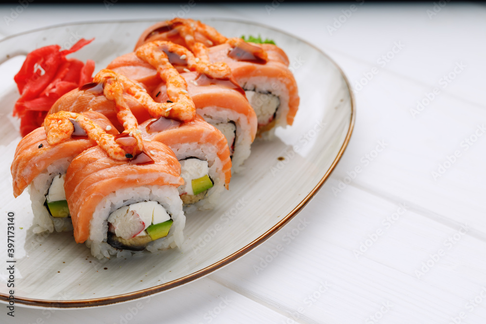 Philadelphia sushi roll served on plate on white table Philadelphia sushi roll served on plate on white table